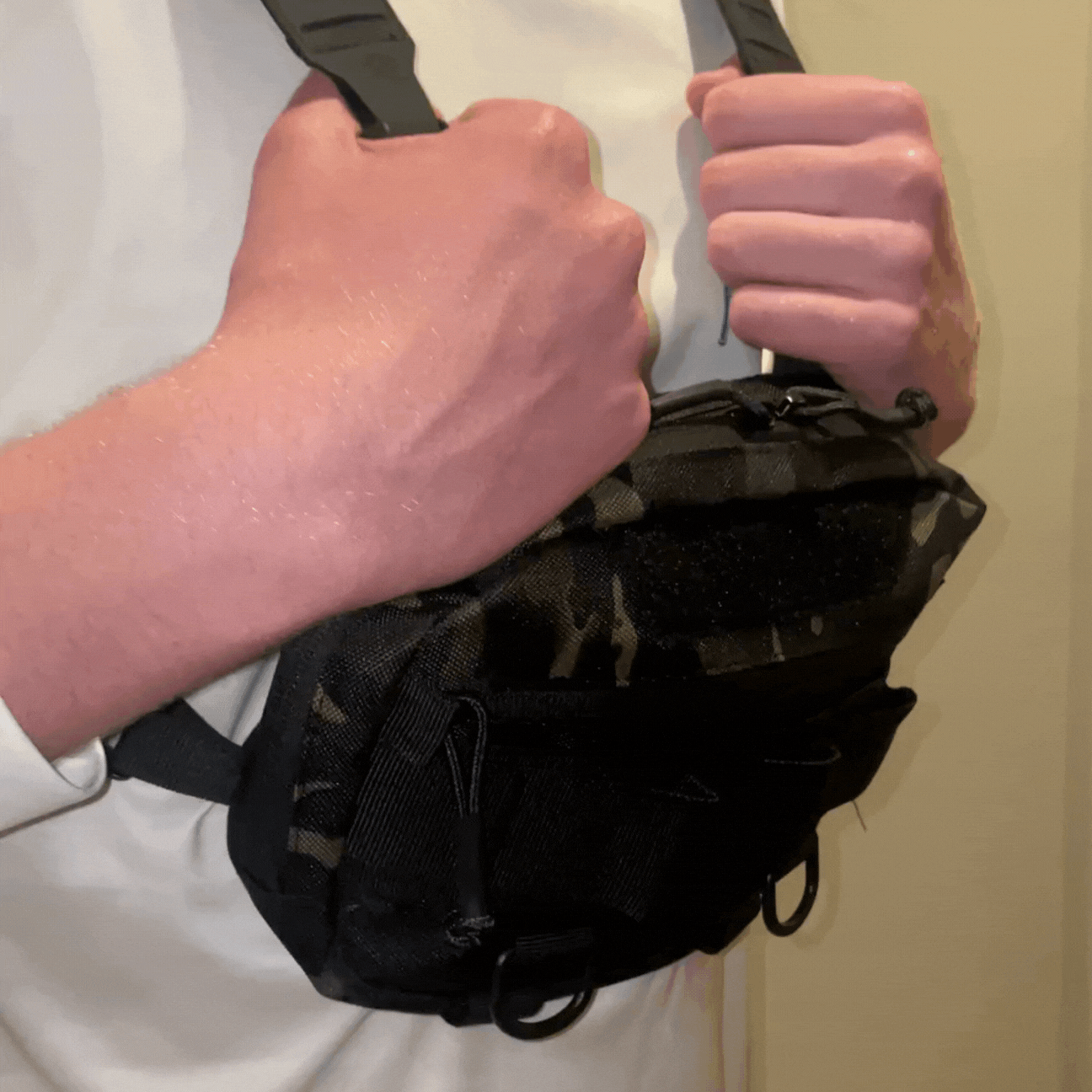 GIF showing person adjusting straps on tactical chest bag for a secure and comfortable fit during everyday carry.